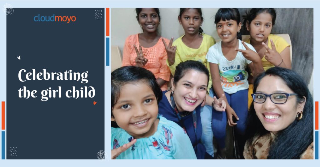 Blue CloudMoyo social image that says "Celebrating the girl child" and an image of CloudMoyo employees taking a selfie with Mahatma Gandhi School students.